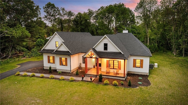 1332 S Rd, South Kingstown, RI 02879 - modern inspired farmhouse with covered porch, a yard, a shingled roof, view of scattered trees, and central AC