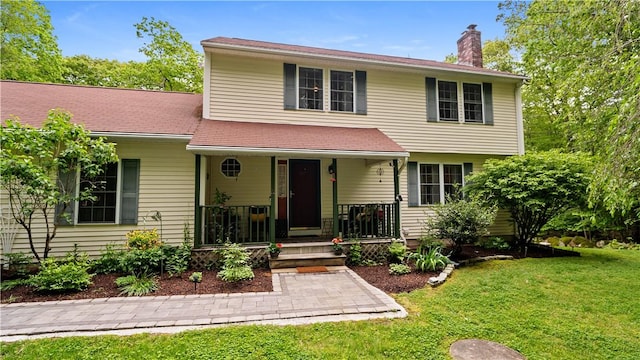605 Gardner Rd, Exeter, RI 02822 - colonial-style house with a chimney, a front yard, and a porch