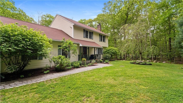 605 Gardner Rd, Exeter, RI 02822 - back of property featuring a chimney, a yard, and covered porch