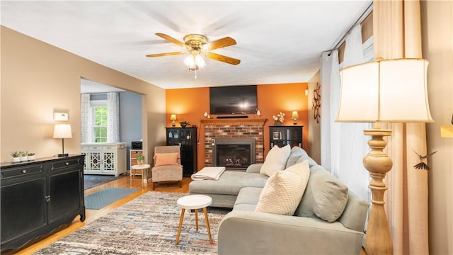 605 Gardner Rd, Exeter, RI 02822 - living room featuring wood finished floors, a ceiling fan, and a brick fireplace