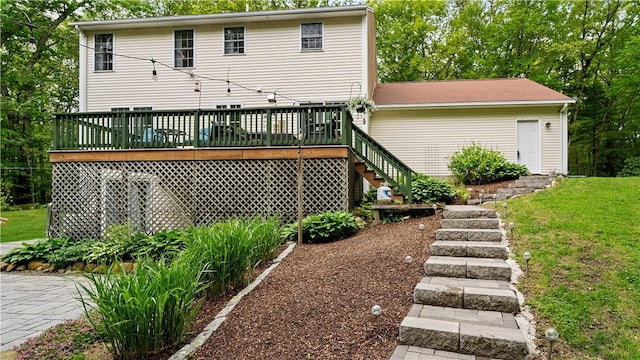 605 Gardner Rd, Exeter, RI 02822 - back of property with stairway, a deck, and a lawn