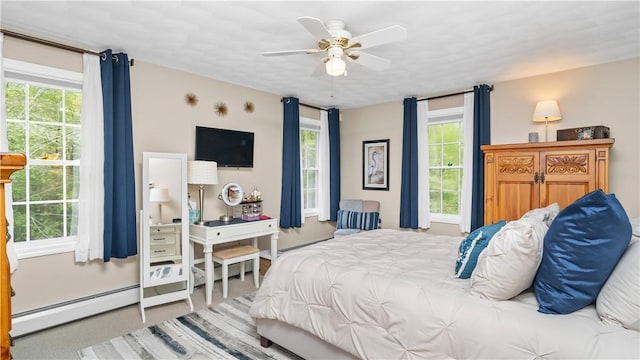 605 Gardner Rd, Exeter, RI 02822 - bedroom featuring a baseboard radiator, multiple windows, and a ceiling fan