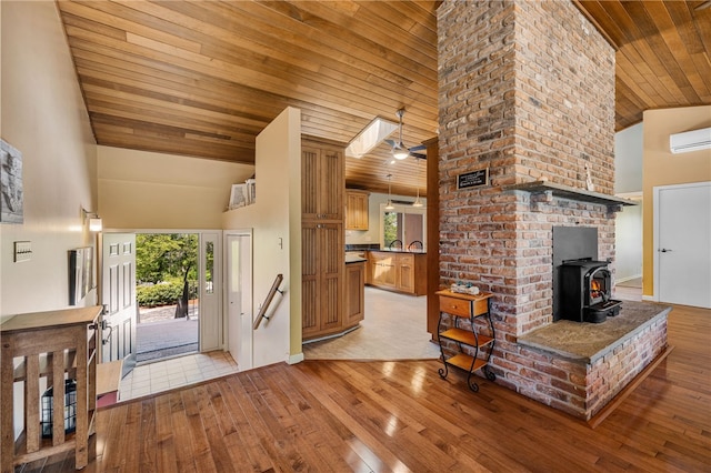 11 Cove Rd, Narragansett, RI 02882 - foyer featuring high vaulted ceiling, wooden ceiling, a wood stove, light wood-type flooring, and an AC wall unit