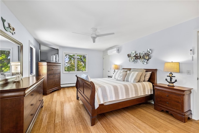 11 Cove Rd, Narragansett, RI 02882 - bedroom with an AC wall unit, light wood finished floors, baseboard heating, and ceiling fan
