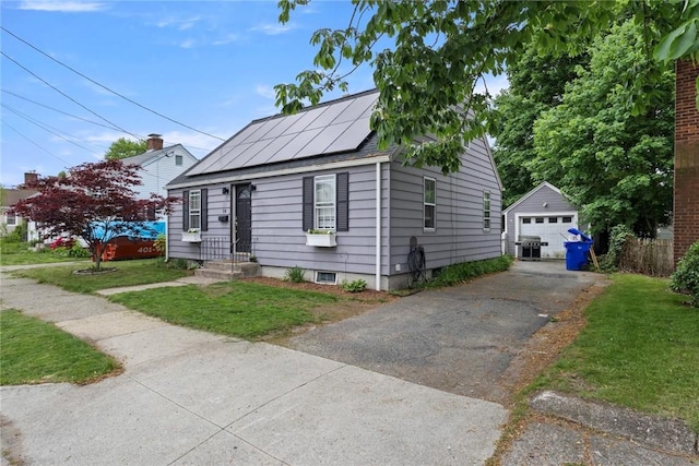58 Edgemere Rd, Pawtucket, RI 02861 - bungalow-style home featuring driveway, a garage, an outdoor structure, solar panels, and a front yard