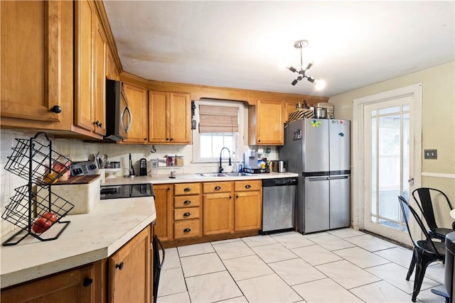 58 Edgemere Rd, Pawtucket, RI 02861 - kitchen with stainless steel appliances, a sink, light countertops, and brown cabinetry