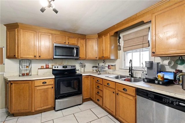 58 Edgemere Rd, Pawtucket, RI 02861 - kitchen featuring appliances with stainless steel finishes, a sink, light countertops, and brown cabinets