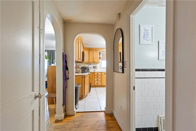 58 Edgemere Rd, Pawtucket, RI 02861 - hallway with light wood-type flooring, arched walkways, and baseboards