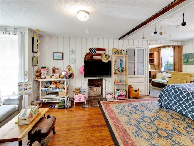 219 Nanaquaket Rd, Tiverton, RI 02878 - bedroom with a textured ceiling, wood finished floors, and wood walls