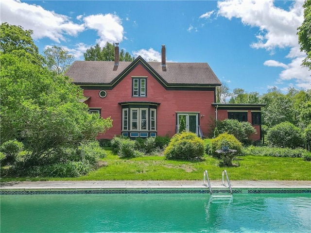219 Nanaquaket Rd, Tiverton, RI 02878 - back of house with an outdoor pool, a chimney, and a yard
