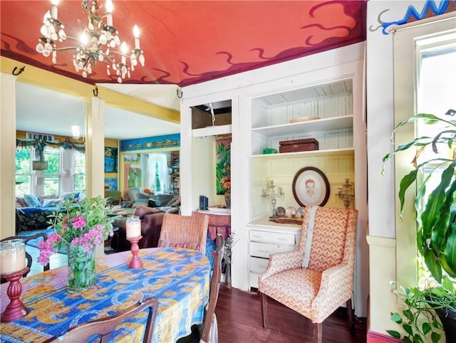 219 Nanaquaket Rd, Tiverton, RI 02878 - dining room with ornate columns, wood finished floors, a chandelier, and built in shelves
