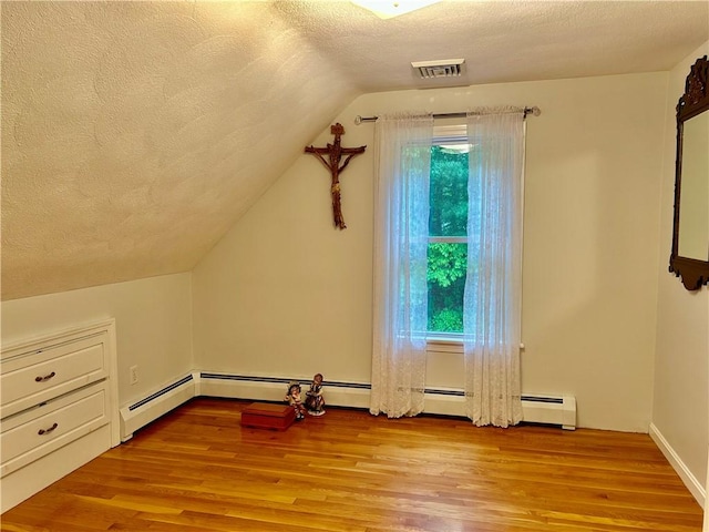 261 John Potter Rd, West Greenwich, RI 02817 - additional living space with a textured ceiling, light wood-style floors, and vaulted ceiling