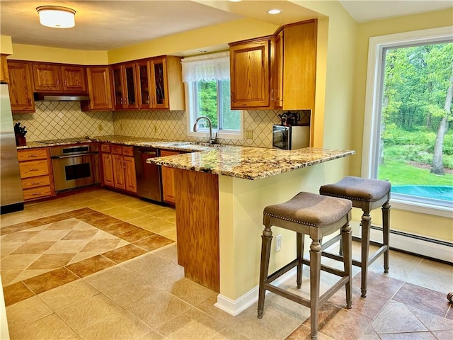 261 John Potter Rd, West Greenwich, RI 02817 - kitchen featuring stainless steel appliances, a sink, brown cabinets, under cabinet range hood, and recessed lighting