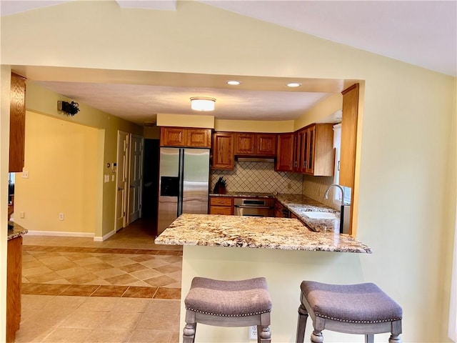 261 John Potter Rd, West Greenwich, RI 02817 - kitchen featuring stainless steel fridge, a sink, a peninsula, under cabinet range hood, and tasteful backsplash