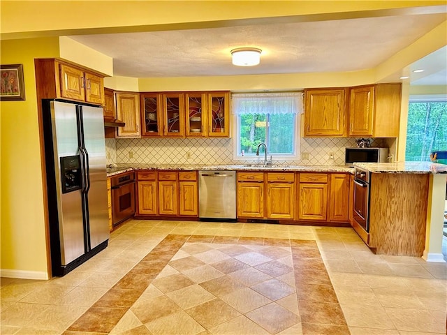 261 John Potter Rd, West Greenwich, RI 02817 - kitchen featuring appliances with stainless steel finishes, brown cabinetry, and a sink