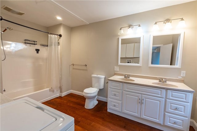 18 Railroad Ave, South Kingstown, RI 02892 - bathroom featuring wood finished floors, washer / dryer, toilet, double vanity, and shower / bath combo