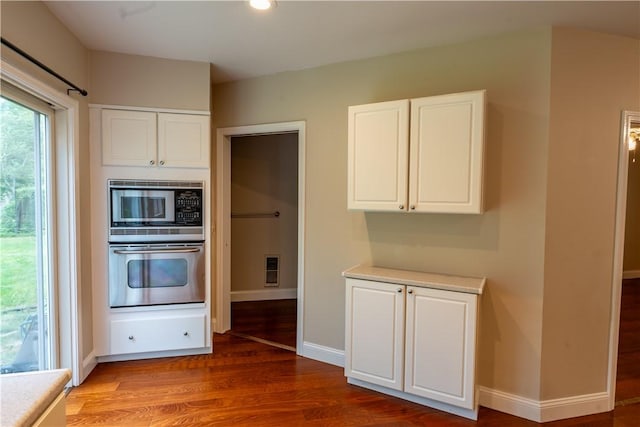 18 Railroad Ave, South Kingstown, RI 02892 - kitchen with appliances with stainless steel finishes, white cabinets, wood finished floors, light countertops, and baseboards