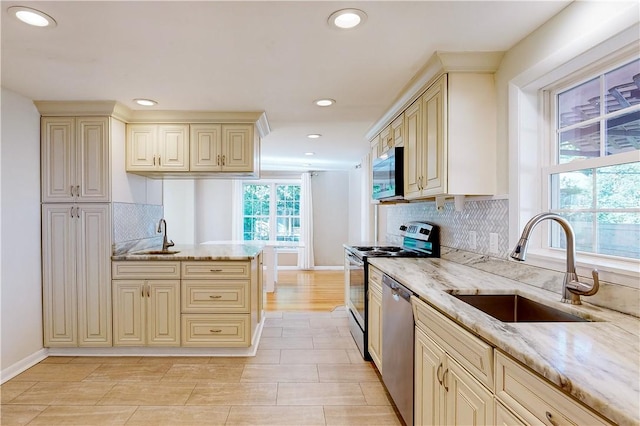 23 Sarah St, Providence, RI 02906 - kitchen with cream cabinetry, appliances with stainless steel finishes, a sink, light stone counters, and recessed lighting