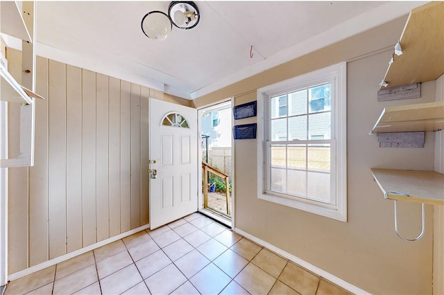 23 Sarah St, Providence, RI 02906 - foyer with baseboards, light tile patterned floors, and wood walls