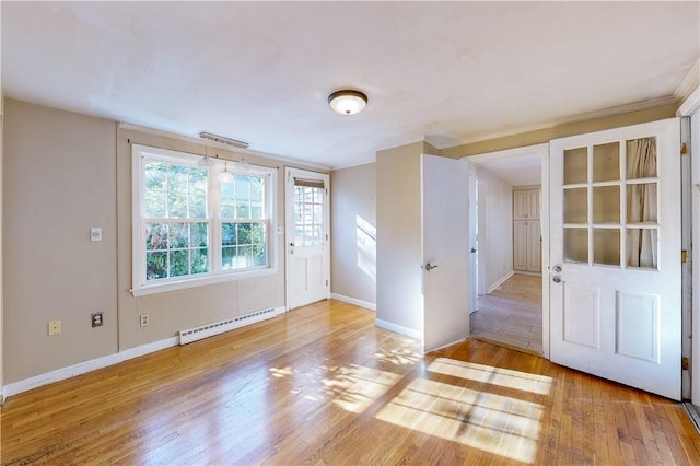 23 Sarah St, Providence, RI 02906 - foyer featuring a baseboard heating unit, light wood-type flooring, baseboards, and ornamental molding