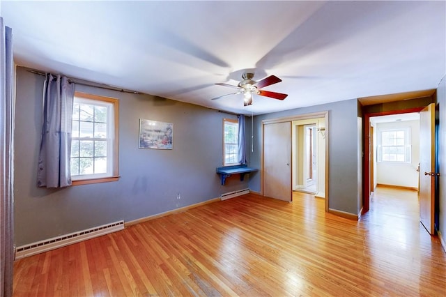 23 Sarah St, Providence, RI 02906 - unfurnished bedroom featuring baseboard heating, light wood-style flooring, a baseboard heating unit, and baseboards