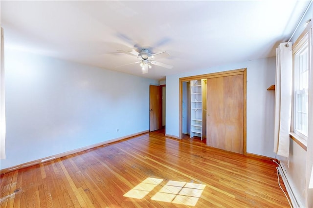 23 Sarah St, Providence, RI 02906 - unfurnished bedroom featuring a baseboard radiator, light wood finished floors, baseboards, and a ceiling fan