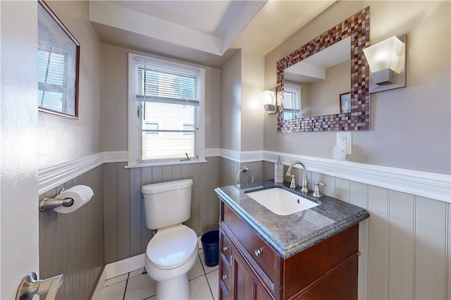 23 Sarah St, Providence, RI 02906 - half bath with a wainscoted wall, toilet, vanity, and tile patterned flooring