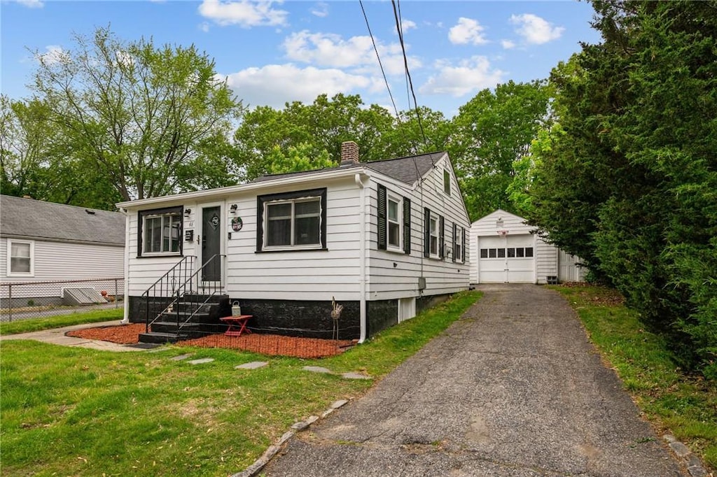 46 Riverside Ave, Johnston, RI 02919 - view of front facade with an outdoor structure, a garage, a chimney, entry steps, and a front lawn