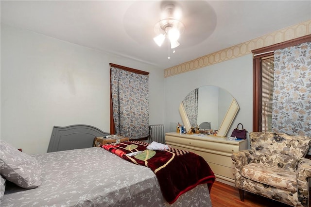 85 Englewood Ave, Pawtucket, RI 02860 - bedroom with wood finished floors, arched walkways, radiator, and a ceiling fan