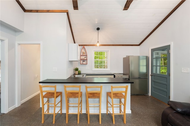 25 Melissa Ln, Burrillville, RI 02859 - kitchen featuring freestanding refrigerator, lofted ceiling, dark countertops, a sink, and a kitchen breakfast bar