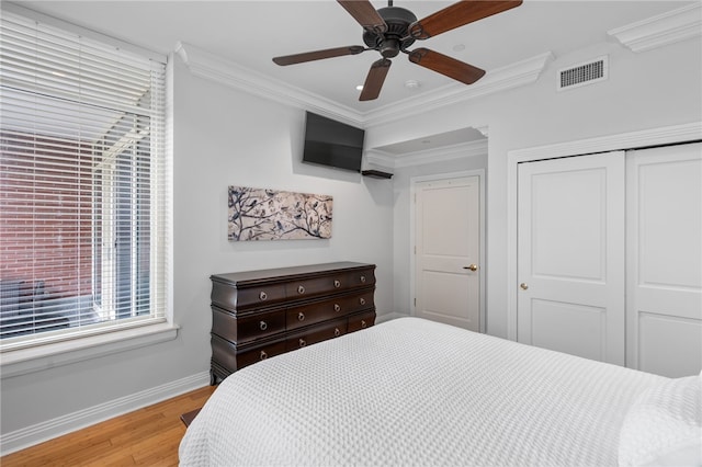 341 Thames St Unit 103, Bristol, RI 02809 - bedroom with a closet, ornamental molding, baseboards, light wood finished floors, and ceiling fan