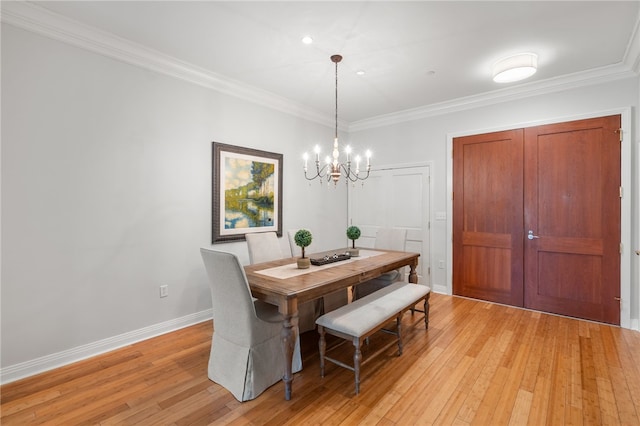 341 Thames St Unit 103, Bristol, RI 02809 - dining space featuring light wood finished floors, a chandelier, crown molding, and baseboards