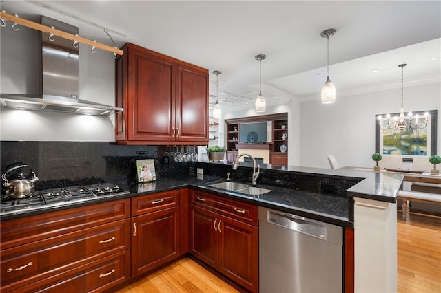 341 Thames St Unit 103, Bristol, RI 02809 - kitchen featuring a sink, stainless steel appliances, wall chimney exhaust hood, a peninsula, and crown molding