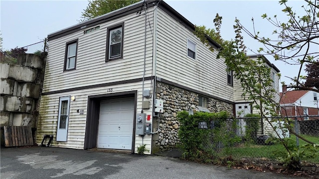155 Thomas St, Woonsocket, RI 02895 - view of side of home with a garage and stone siding