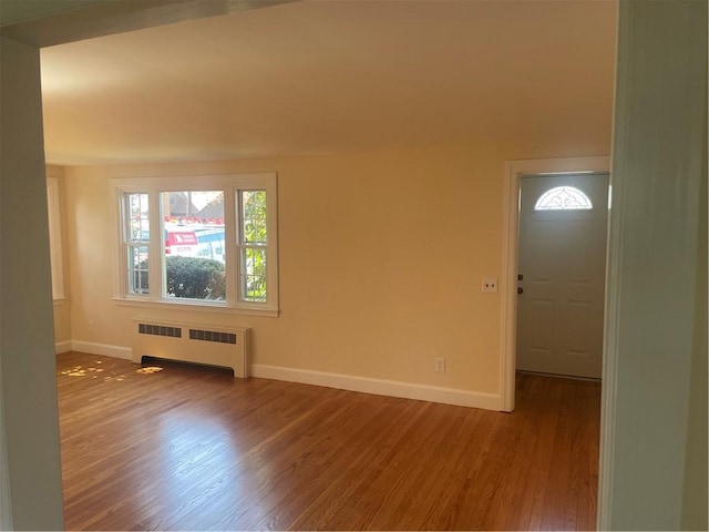 80 Frontier Rd, Warwick, RI 02889 - unfurnished room with radiator heating unit, baseboards, and wood finished floors