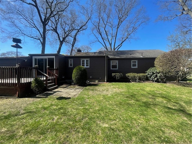 80 Frontier Rd, Warwick, RI 02889 - rear view of house featuring a deck, a lawn, and a chimney