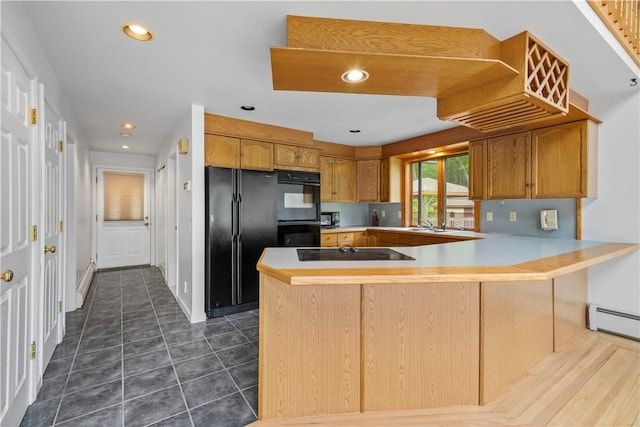 121 W Shore Dr, Exeter, RI 02822 - kitchen featuring black appliances, a peninsula, light countertops, a baseboard heating unit, and brown cabinetry