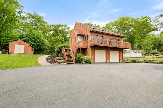 121 W Shore Dr, Exeter, RI 02822 - chalet / cabin with driveway, a garage, a front lawn, stairs, and view of wooded area