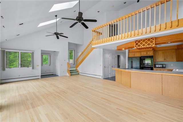 121 W Shore Dr, Exeter, RI 02822 - kitchen with high vaulted ceiling, open floor plan, baseboard heating, a baseboard heating unit, and a skylight