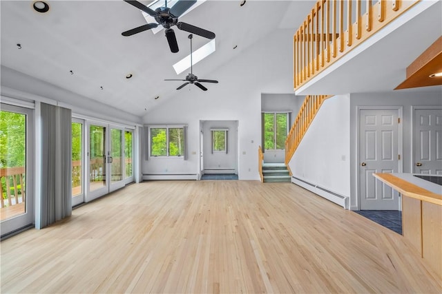 121 W Shore Dr, Exeter, RI 02822 - unfurnished living room featuring a baseboard heating unit, high vaulted ceiling, ceiling fan, wood finished floors, and stairs
