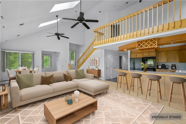 121 W Shore Dr, Exeter, RI 02822 - living room featuring high vaulted ceiling, a skylight, healthy amount of natural light, ceiling fan, and stairway