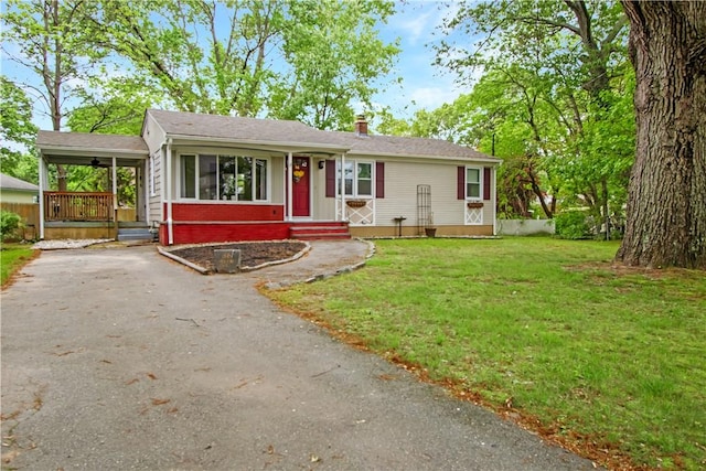 56 Glen Dr, Warwick, RI 02889 - single story home featuring asphalt driveway, a front yard, a chimney, and covered porch