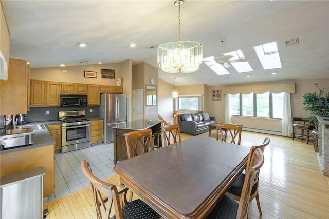 290 E View Ave, Cranston, RI 02920 - dining area featuring vaulted ceiling, a skylight, baseboard heating, a chandelier, and light wood-type flooring