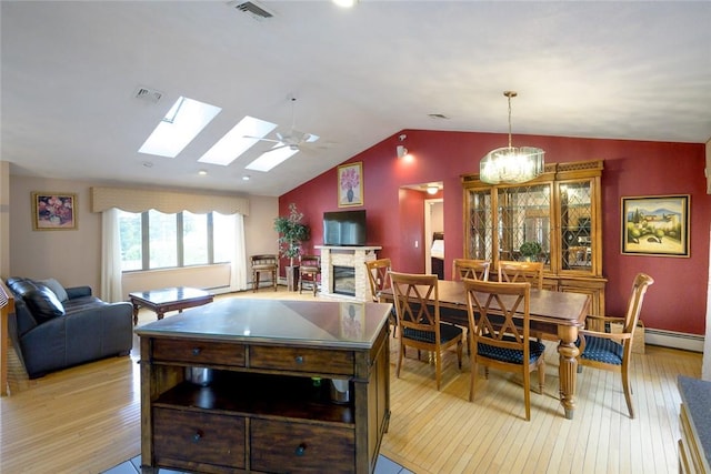 290 E View Ave, Cranston, RI 02920 - kitchen featuring light wood-style flooring, lofted ceiling, a stone fireplace, a skylight, and baseboards