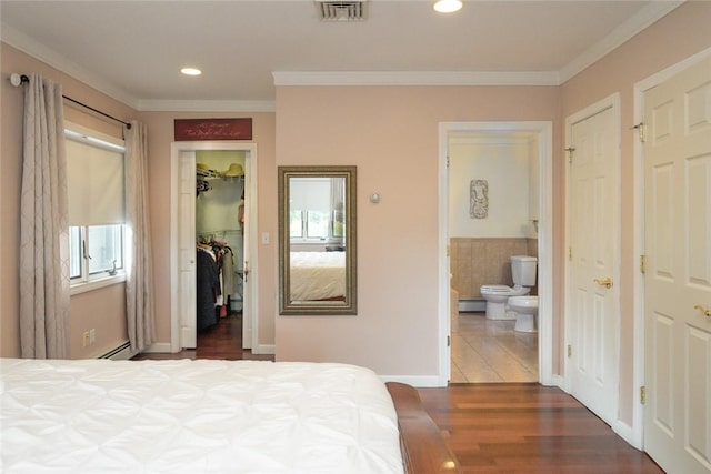 290 E View Ave, Cranston, RI 02920 - bedroom with a baseboard heating unit, wood finished floors, ornamental molding, a walk in closet, and ensuite bath