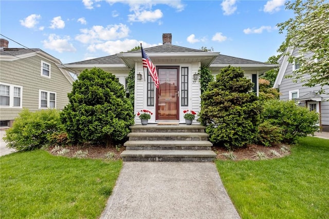 77 Friendly Rd, Cranston, RI 02910 - view of front facade with a front yard and a chimney