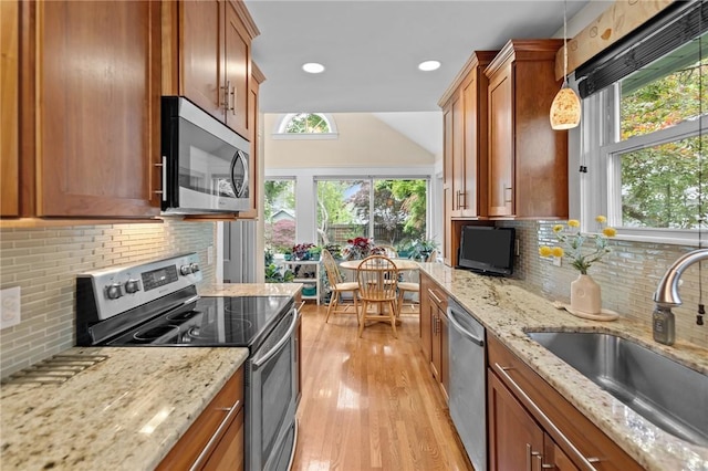 77 Friendly Rd, Cranston, RI 02910 - kitchen featuring stainless steel appliances, a sink, brown cabinets, backsplash, and recessed lighting