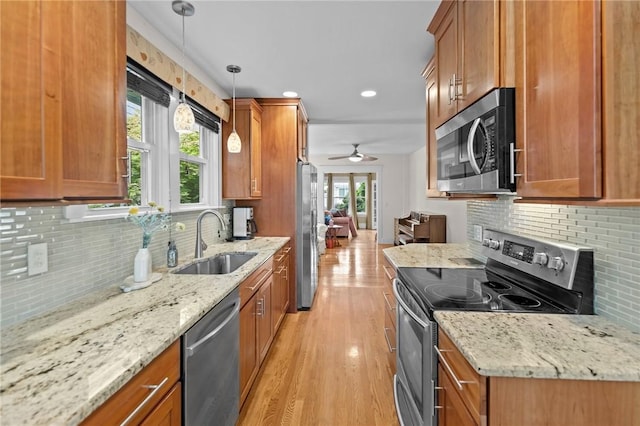 77 Friendly Rd, Cranston, RI 02910 - kitchen featuring stainless steel appliances, a sink, brown cabinets, and recessed lighting