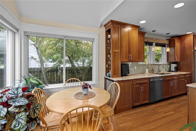 77 Friendly Rd, Cranston, RI 02910 - kitchen featuring dishwasher, a sink, brown cabinetry, light wood-style floors, and decorative backsplash