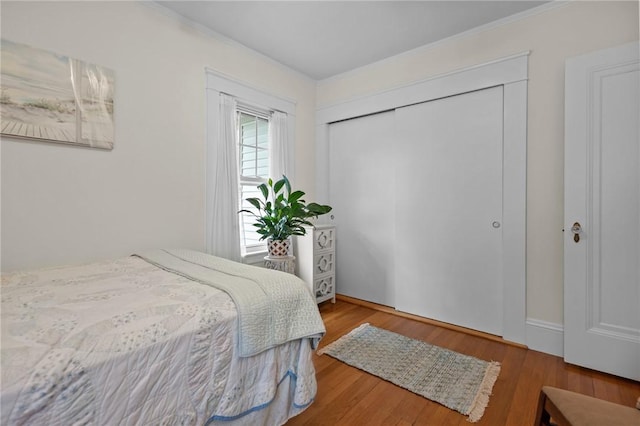 77 Friendly Rd, Cranston, RI 02910 - bedroom with ornamental molding, a closet, and wood finished floors